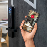 smart door lock with digital keypad and a hand holding a smartphone with a home screen app displayed
